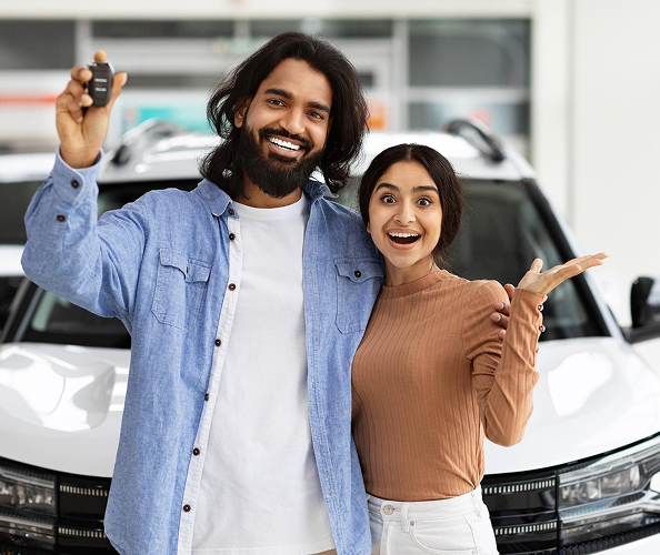 Couple receiving car keys at end of lease